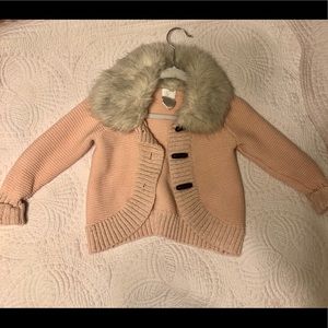 Toddler Girl’s Pink Sweater with fur collar.
